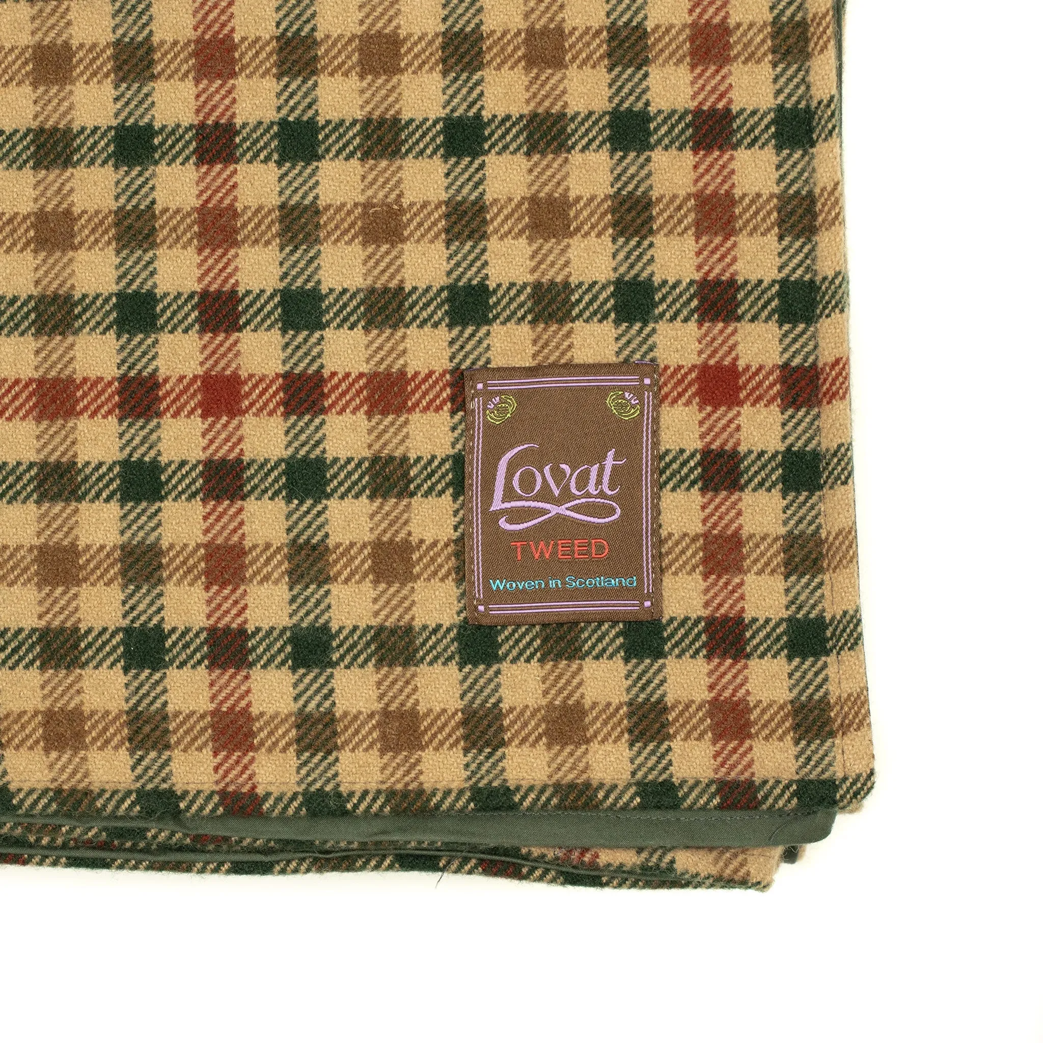 Waxed back picnic blanket in brown, red, and green gunclub lambswool tweed